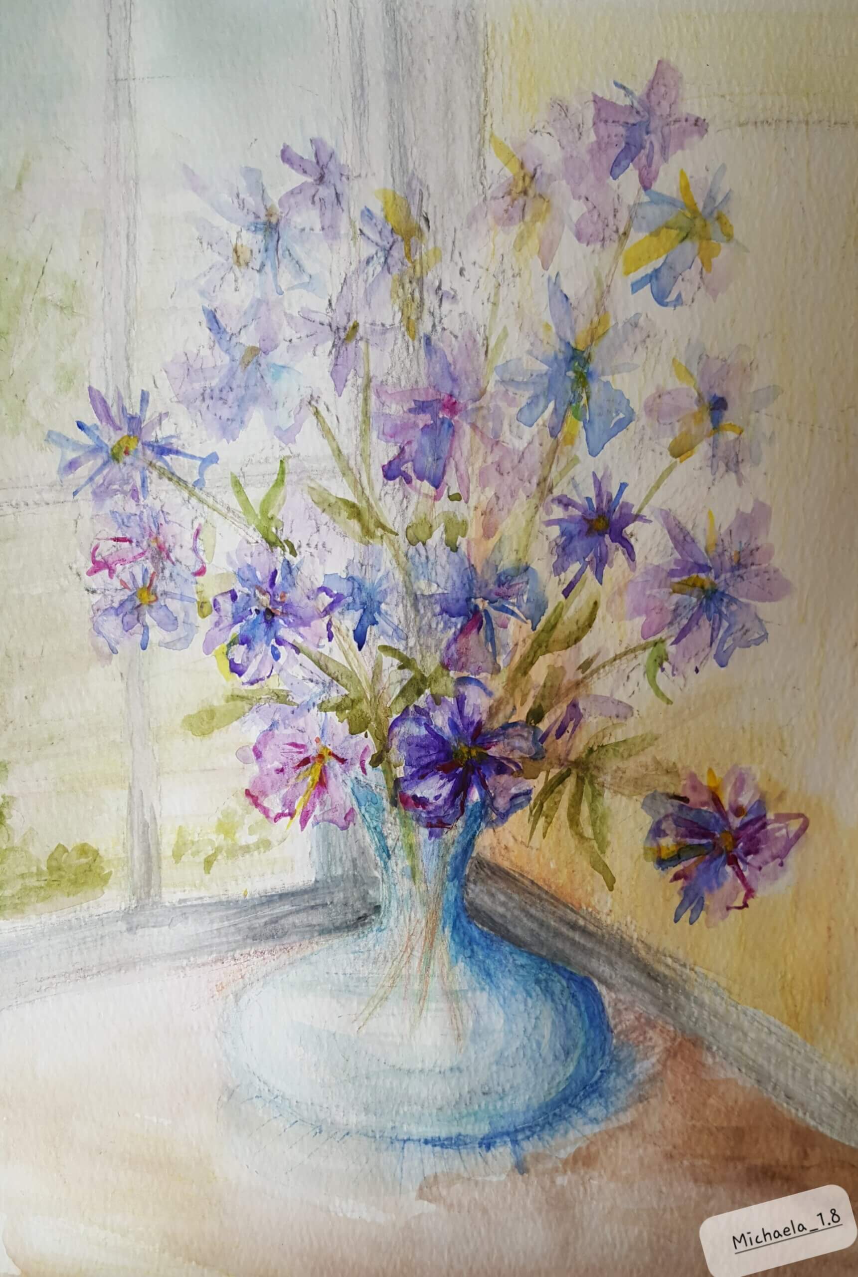 Purple flowers in a blue glass vase