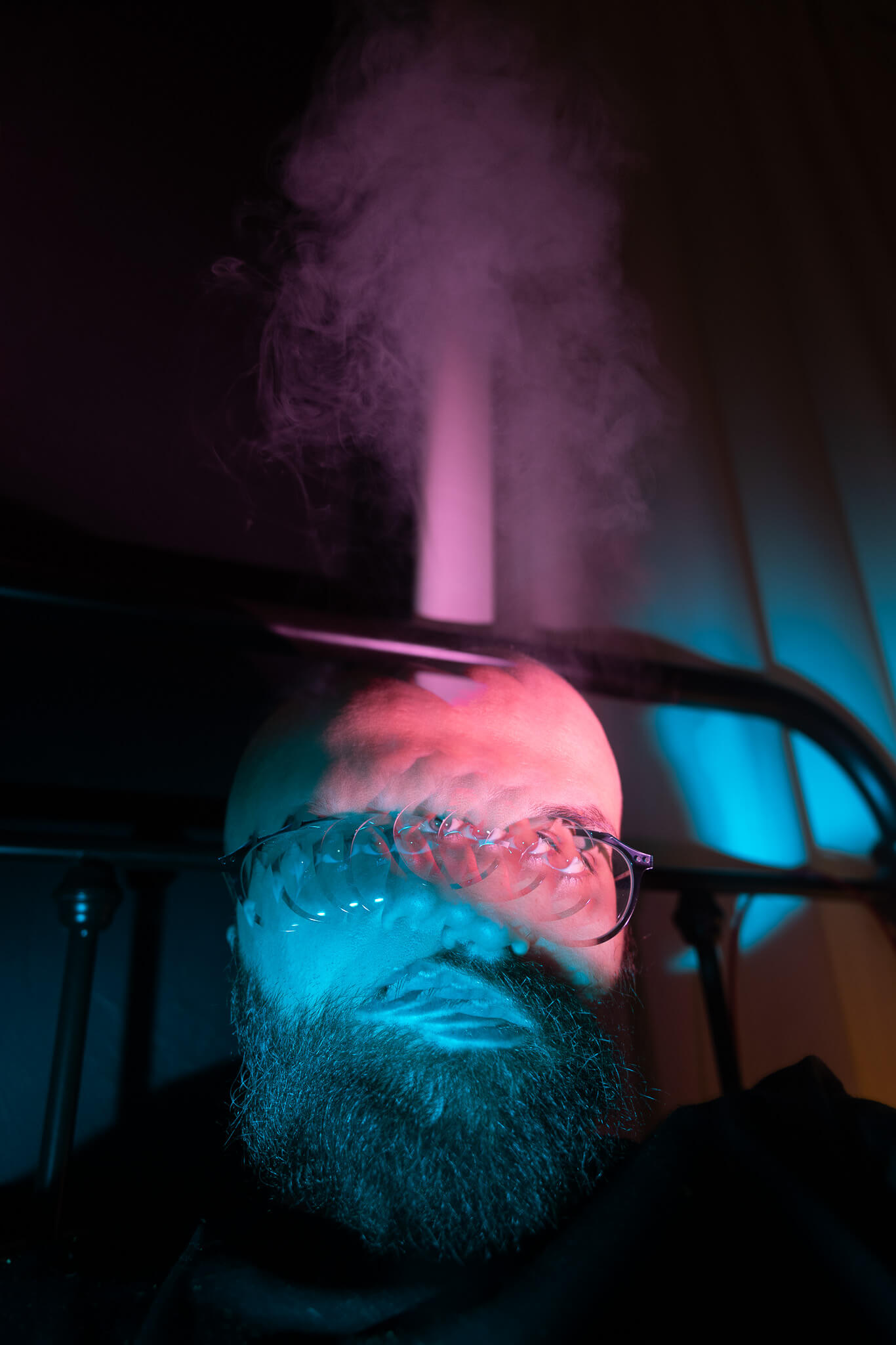 An image of someone in bed with smoke coming out of their head