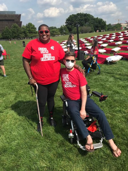 Ben with Brooke Keaton. Red cots in the background.